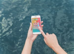 woman-s-hand-using-cellphone-with-social-media-notifications-screen
